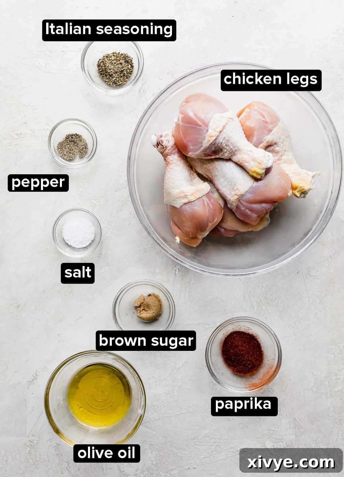 Crispy Air Fryer Drumsticks 3 Air Fryer Chicken Legs ingredients portioned into glass bowls: chicken drumsticks, paprika, olive oil, salt, Italian seasoning, and brown sugar.