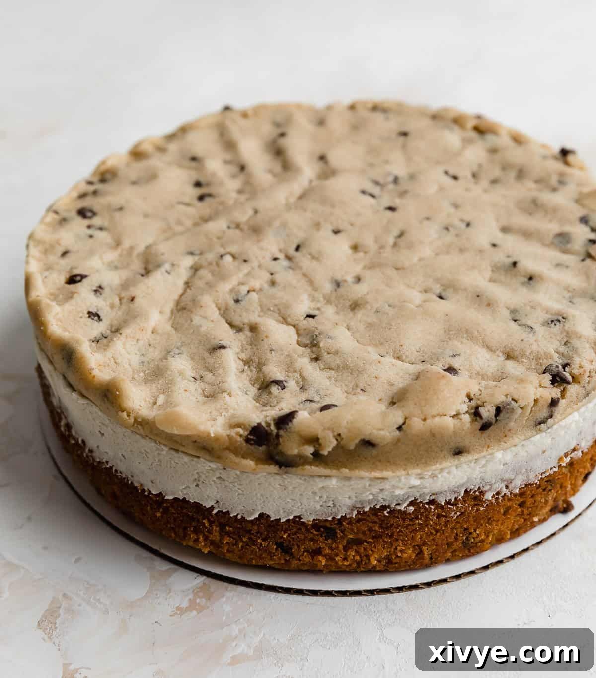 Edible cookie dough layer on top of a frosting coated cake layer.