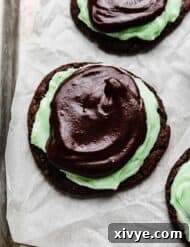 Decadent Mint Brownie Cookie Bliss 11 Crumbl Mint Brownie Cookies on a white parchment paper.