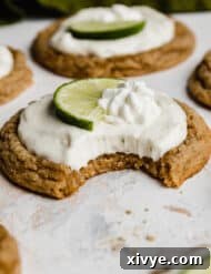 Tangy Key Lime Cookie Delight 12 A bite taken out of a Key Lime Pie Cookie on a white background.
