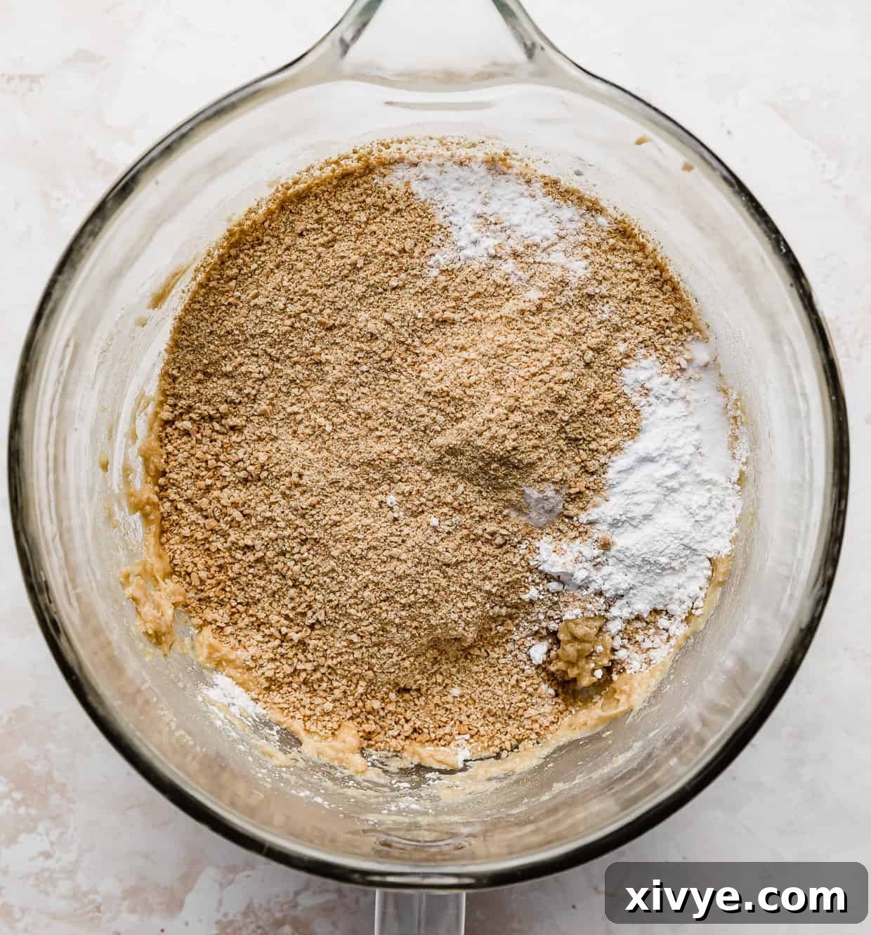 Tangy Key Lime Cookie Delight 3 A mixing bowl with crushed graham cracker crumbs in it for making copycat Crumbl Key Lime Pie Cookies.