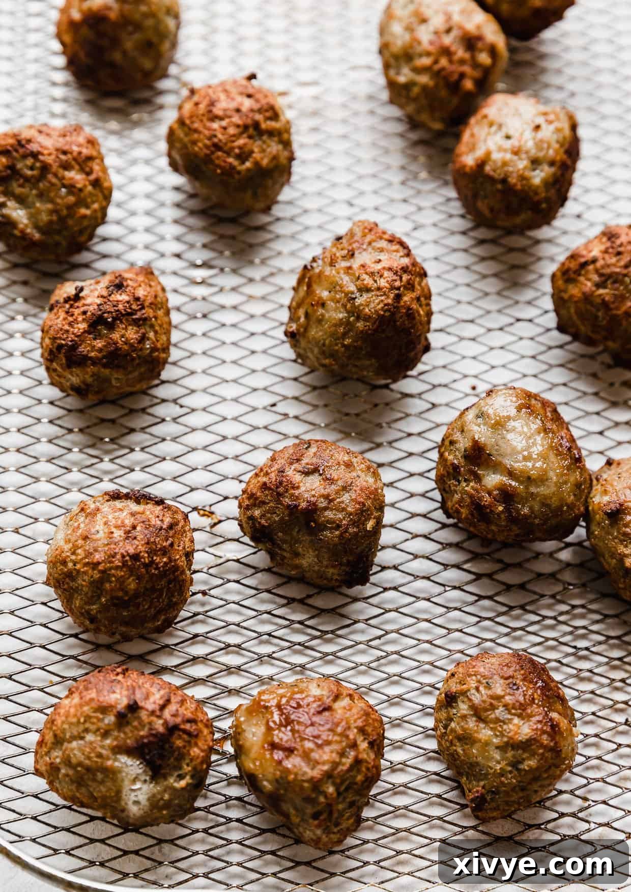 Air fried meatballs on a wire basket.