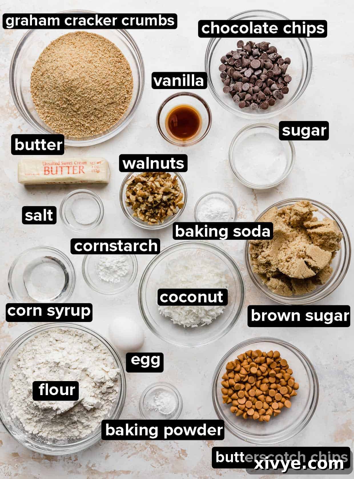 Irresistible Seven-Layer Bars 3 7 Layer Bar Cookies ingredients portioned into glass bowls on a white textured background.