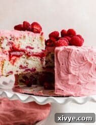 A slice of a two layer Lemon Raspberry Cake, highlighting the perfect layers and filling.