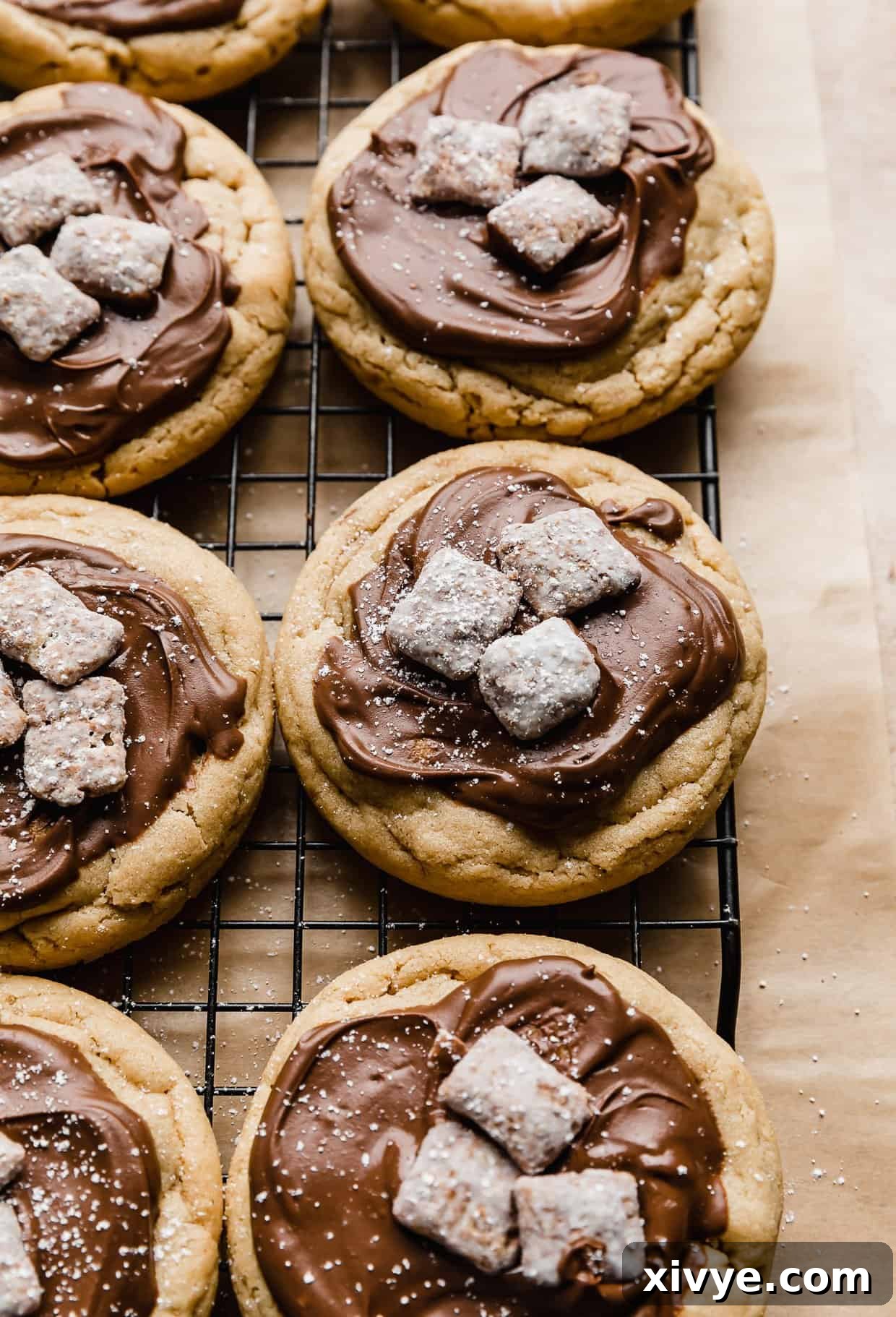 Crumbl Muddy Buddy Cookies arranged neatly on a black wire cooling rack, showcasing their beautiful tops and textures.