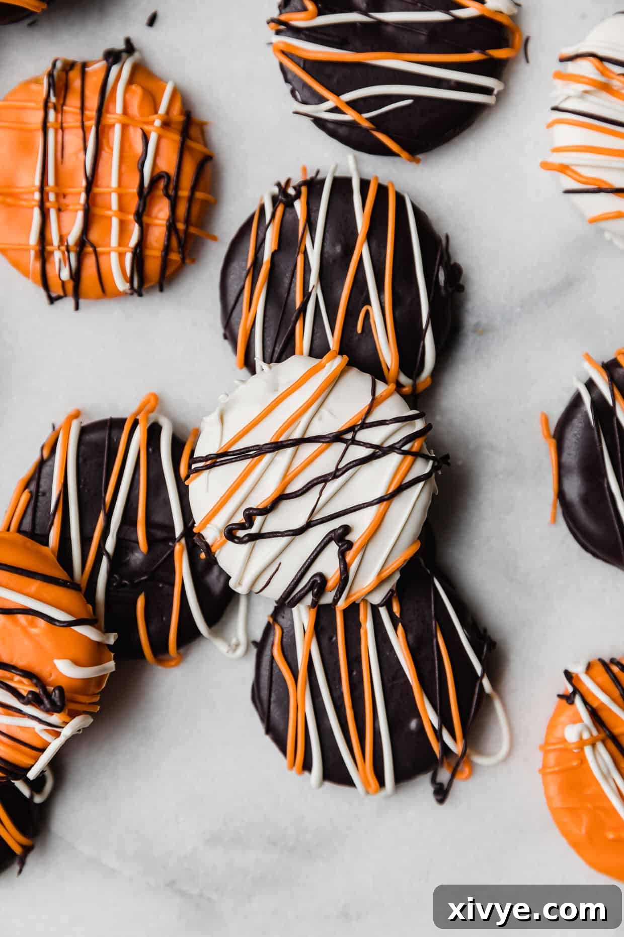 Ritz crackers covered in black, orange, and white chocolate.