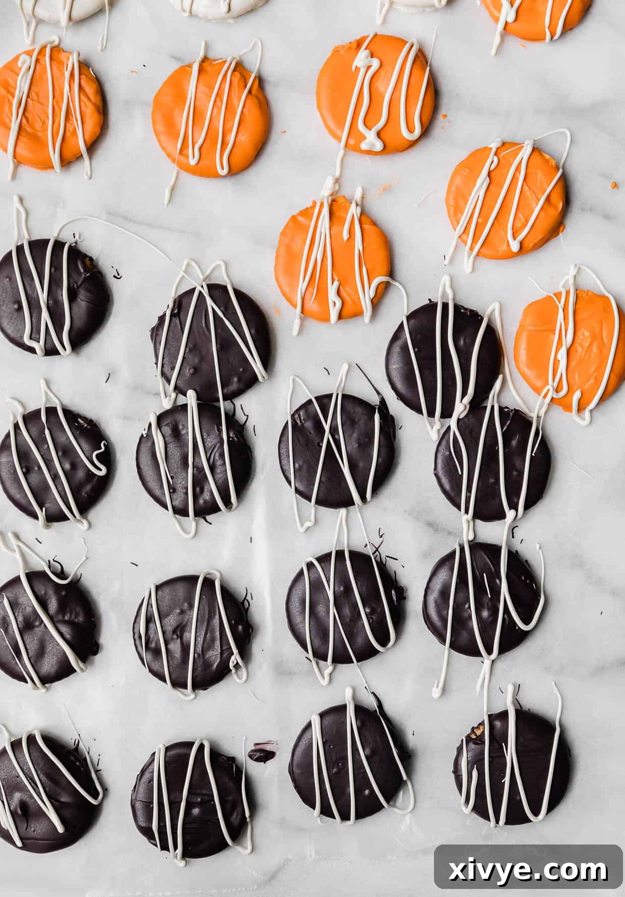White chocolate drizzled overtop black and orange covered Halloween Crackers.