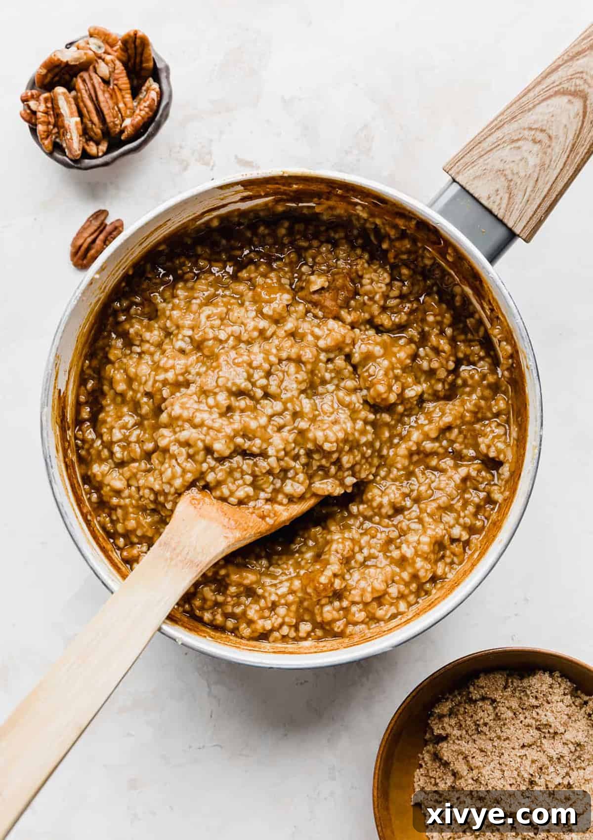 Spiced Pumpkin Steel Cut Oats 7 A wooden spoon stirring Pumpkin Steel Cut Oats.