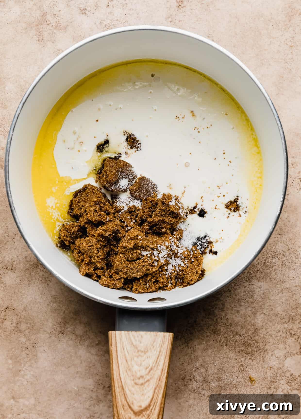 Salted Butterscotch Sauce in a charming glass jar with a small spoon lifting out some of the golden topping.