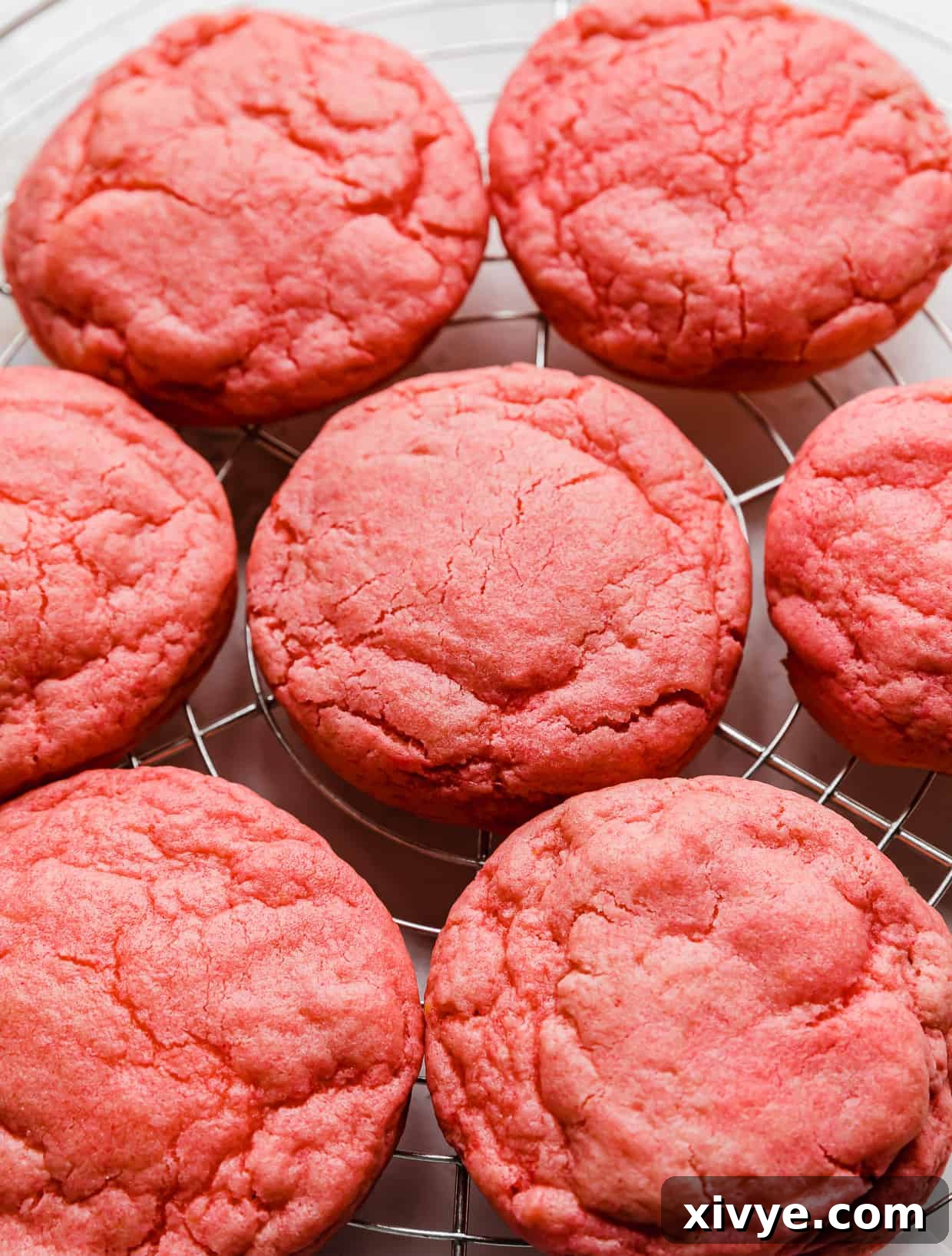 Crumbl Pink Velvet Cookies without frosting, on a wire cooling rack.