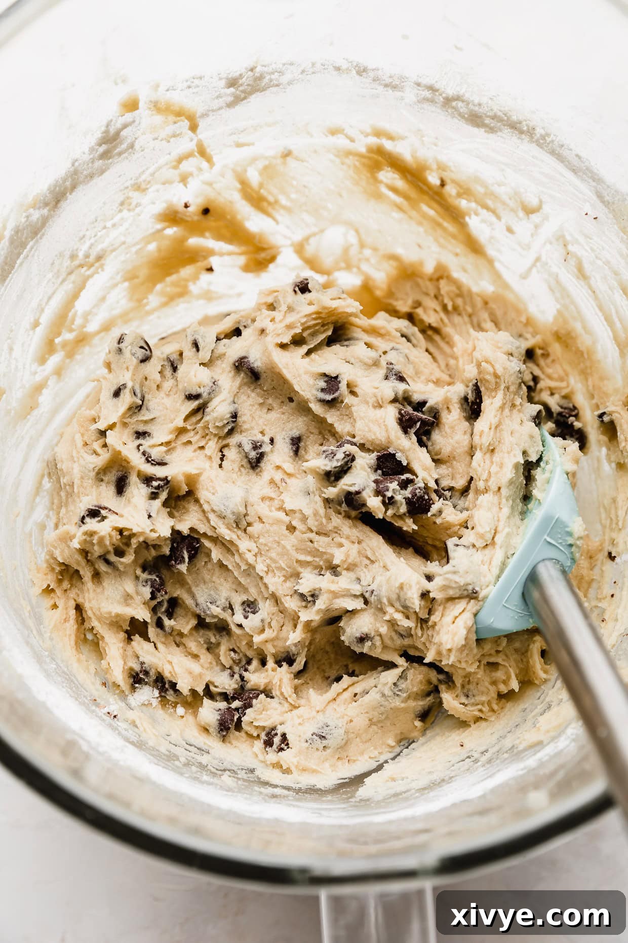 Ultimate Chocolate Chip Cookie Cake 5 Chocolate Chip cookie cake cookie dough in a glass bowl.