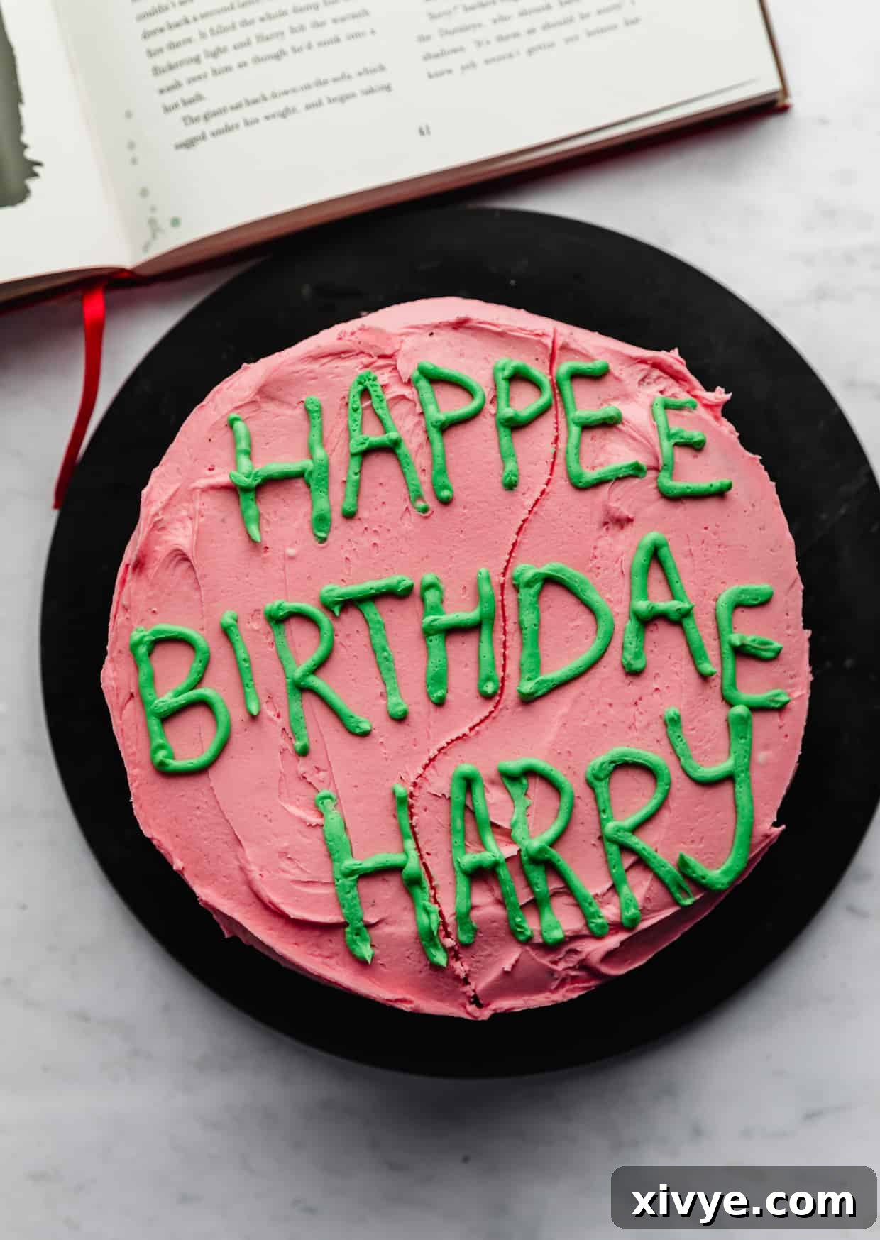 Spellbinding Harry Potter Birthday Delight 2 A pink cake with green frosting writing "Happee Birthdae Harry".