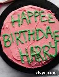 Spellbinding Harry Potter Birthday Delight 13 Hagrid cake that was made for Harry Potters Birthday, pink frosting and green lettering on a black plate.
