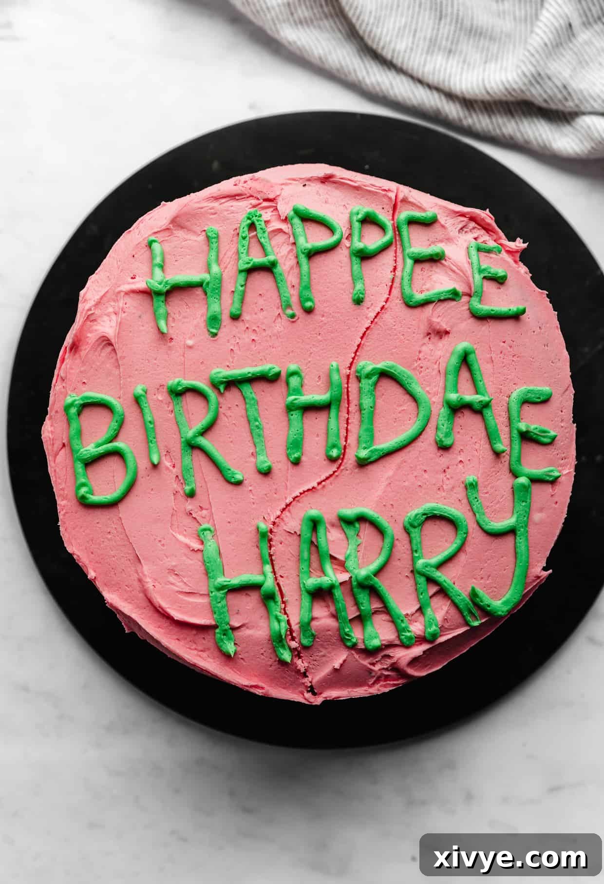 Spellbinding Harry Potter Birthday Delight 10 Happee Birthdae Harry written in green frosting on a pink cake.