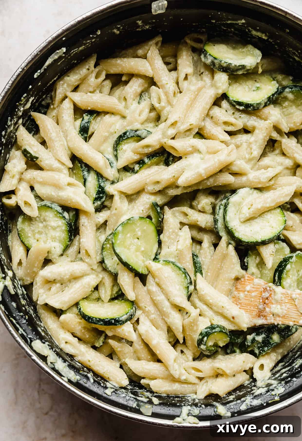 Ricotta Pesto Pasta with Zucchini mixed together in a black pot, showcasing its creamy texture.