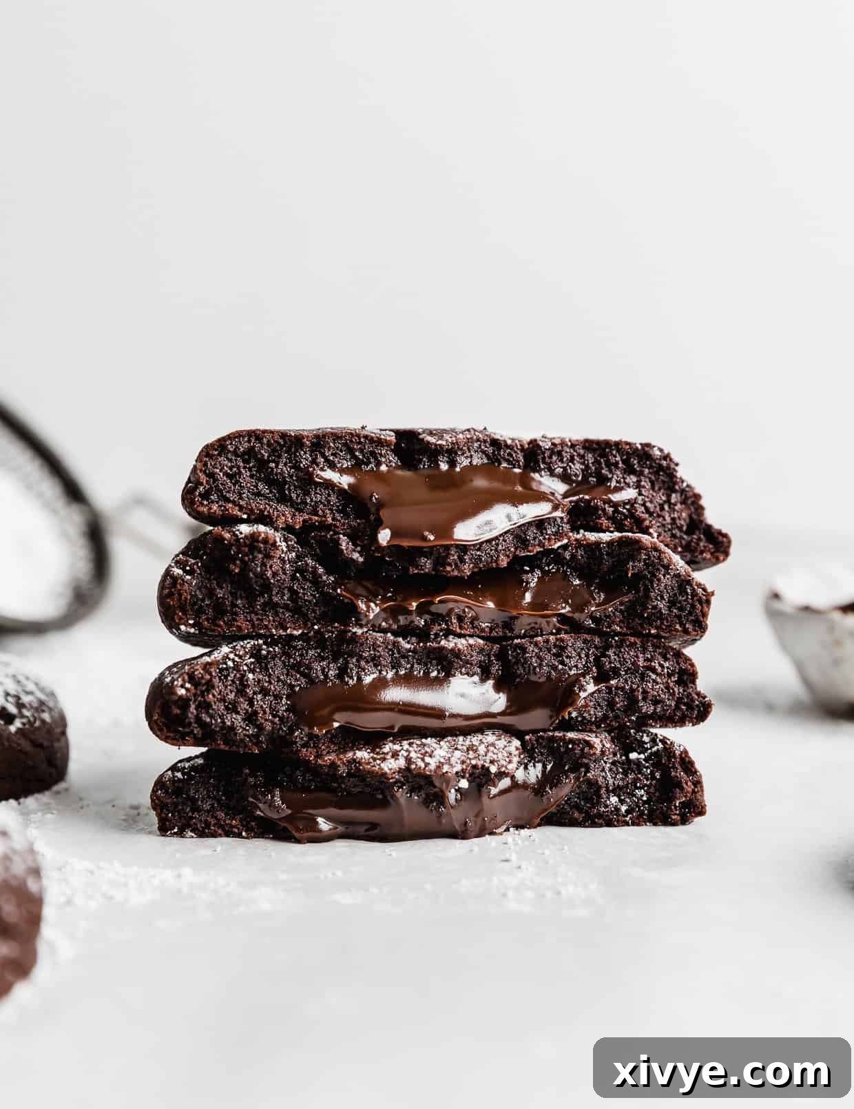 A stack of copycat Crumbl Molten Lava Cookies against a white background.