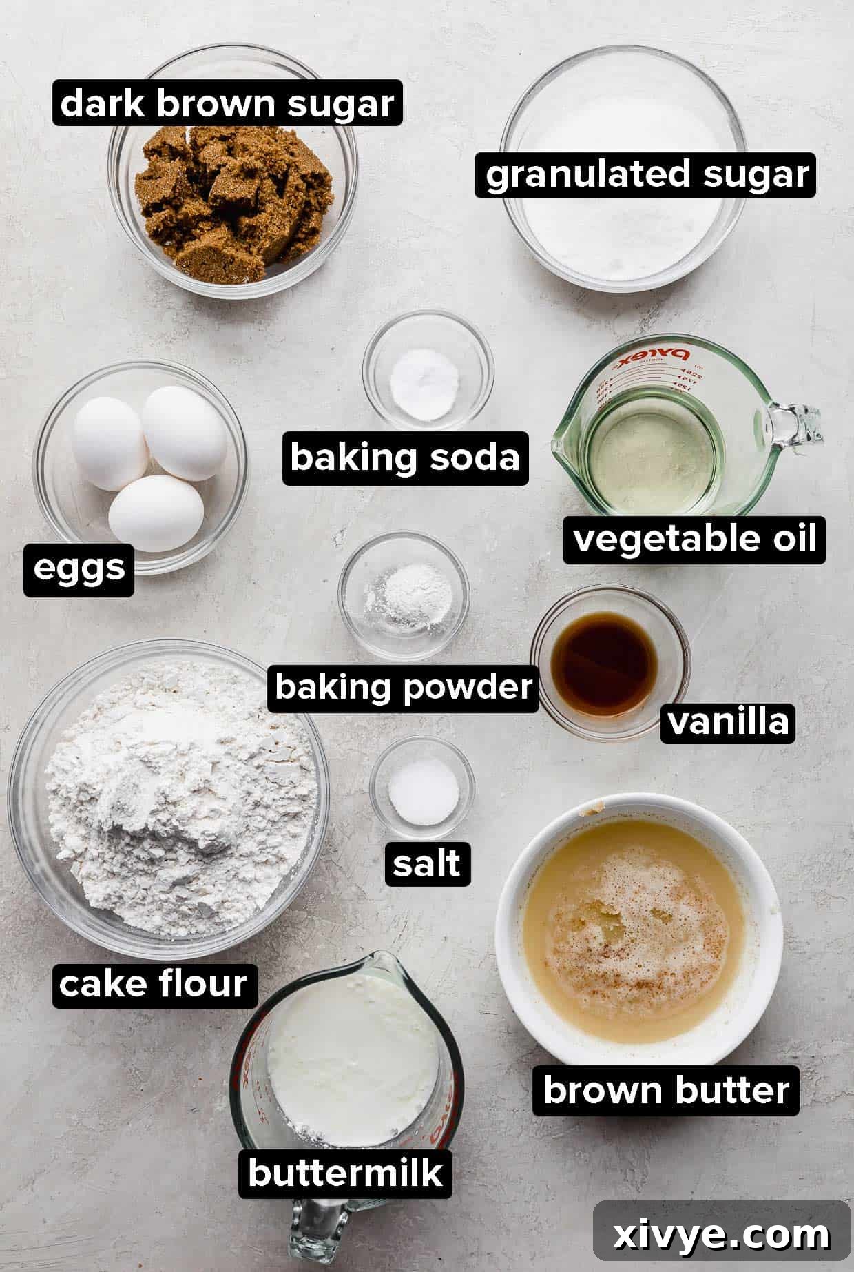 Butterscotch Cake ingredients portioned into glass bowls on a light gray background.