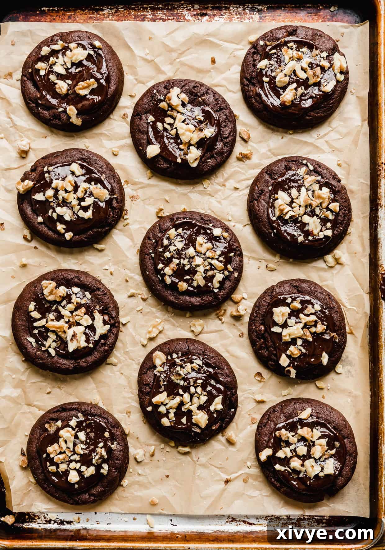 A baking sheet with Crumbl Walnut Fudge Brownie Cookies on the baking sheet.