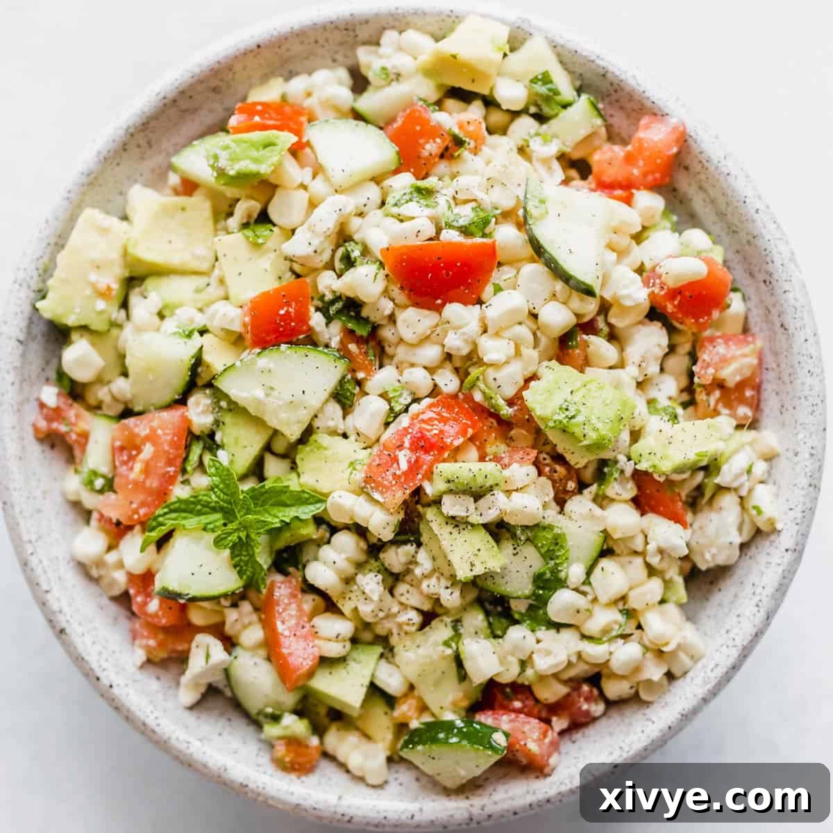 Feta Corn Salad in a bowl on a white background.
