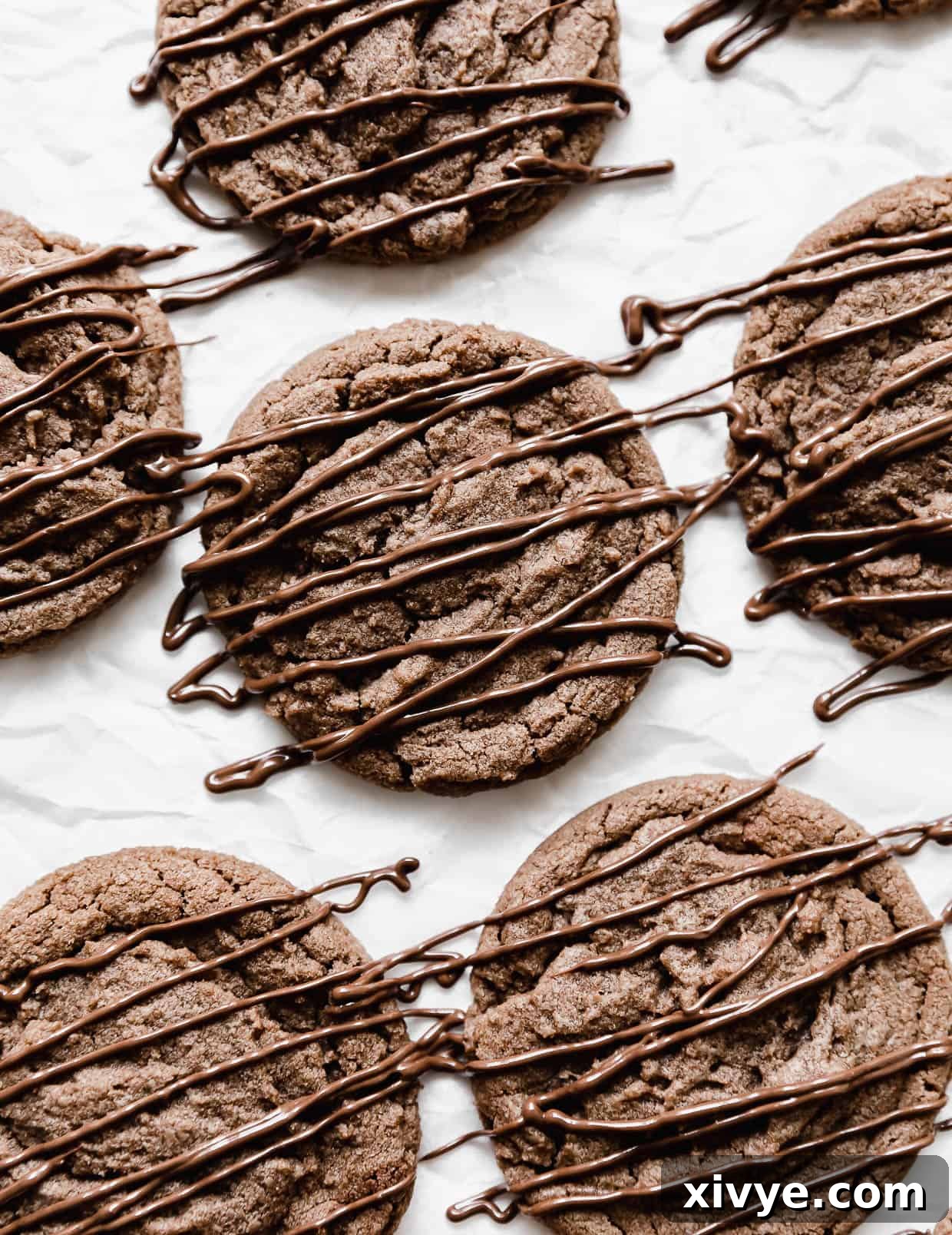 Nutella Cookies with Nutella drizzled overtop of the cookies, showcasing their rich color and inviting texture.