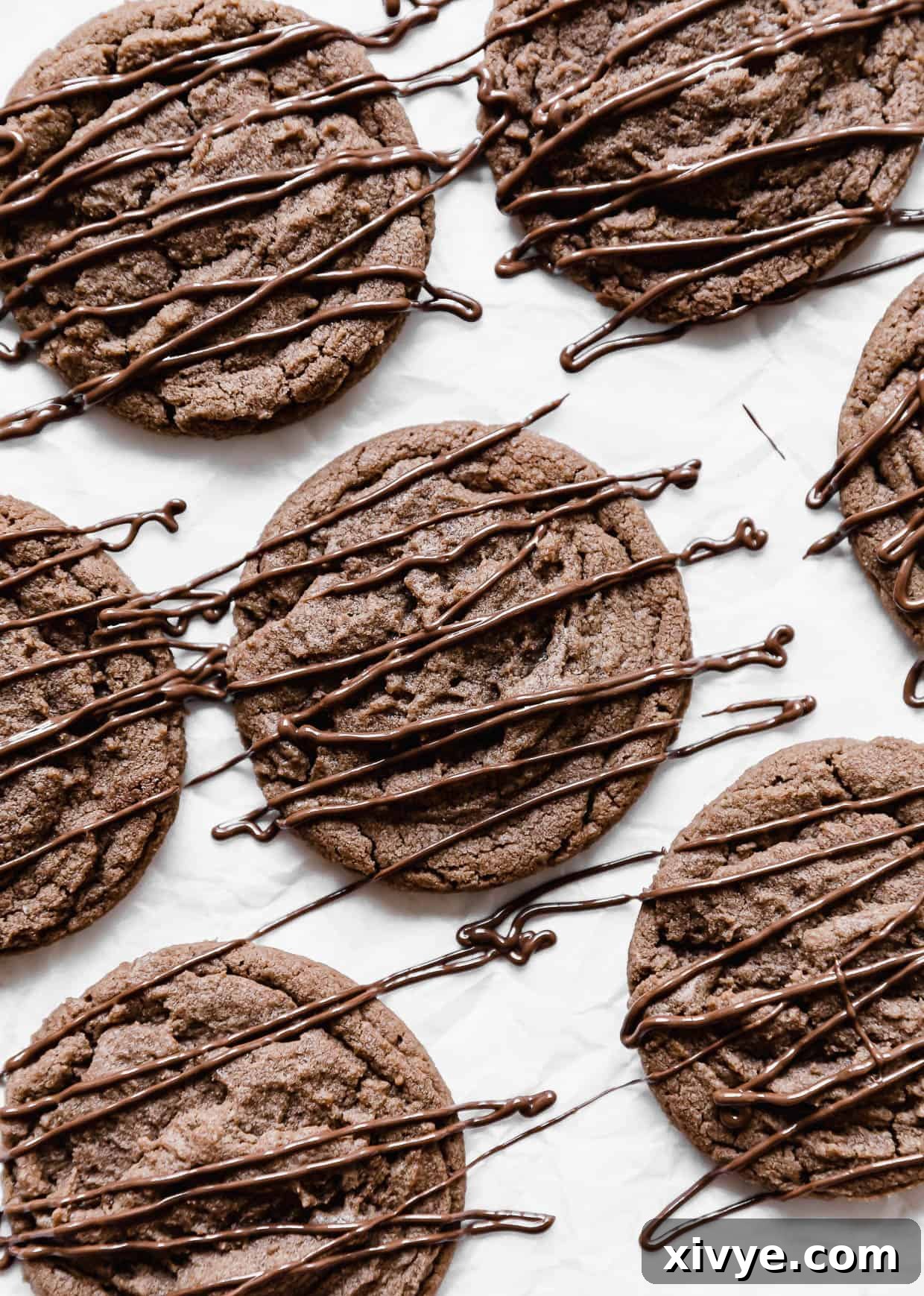 Nutella Cookies drizzled with nutella, on a white background, highlighting their delicious appearance.