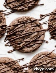 Nutella Cookies on a white background, topped with a drizzle of Nutella.