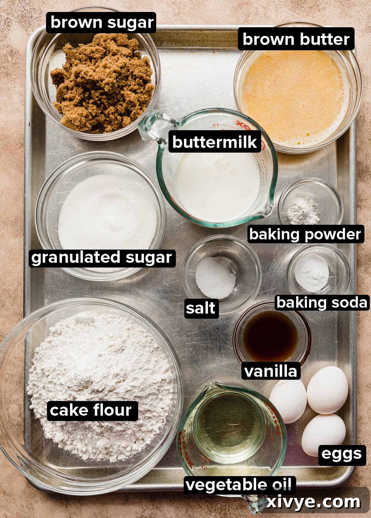 Toasted Butter Dream Cake 3 Brown Butter Cake ingredients portioned into glass bowls on a silver baking sheet.