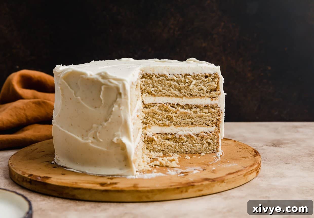Toasted Butter Dream Cake 7 A three layered brown butter cake recipe with a slice removed from the cake.