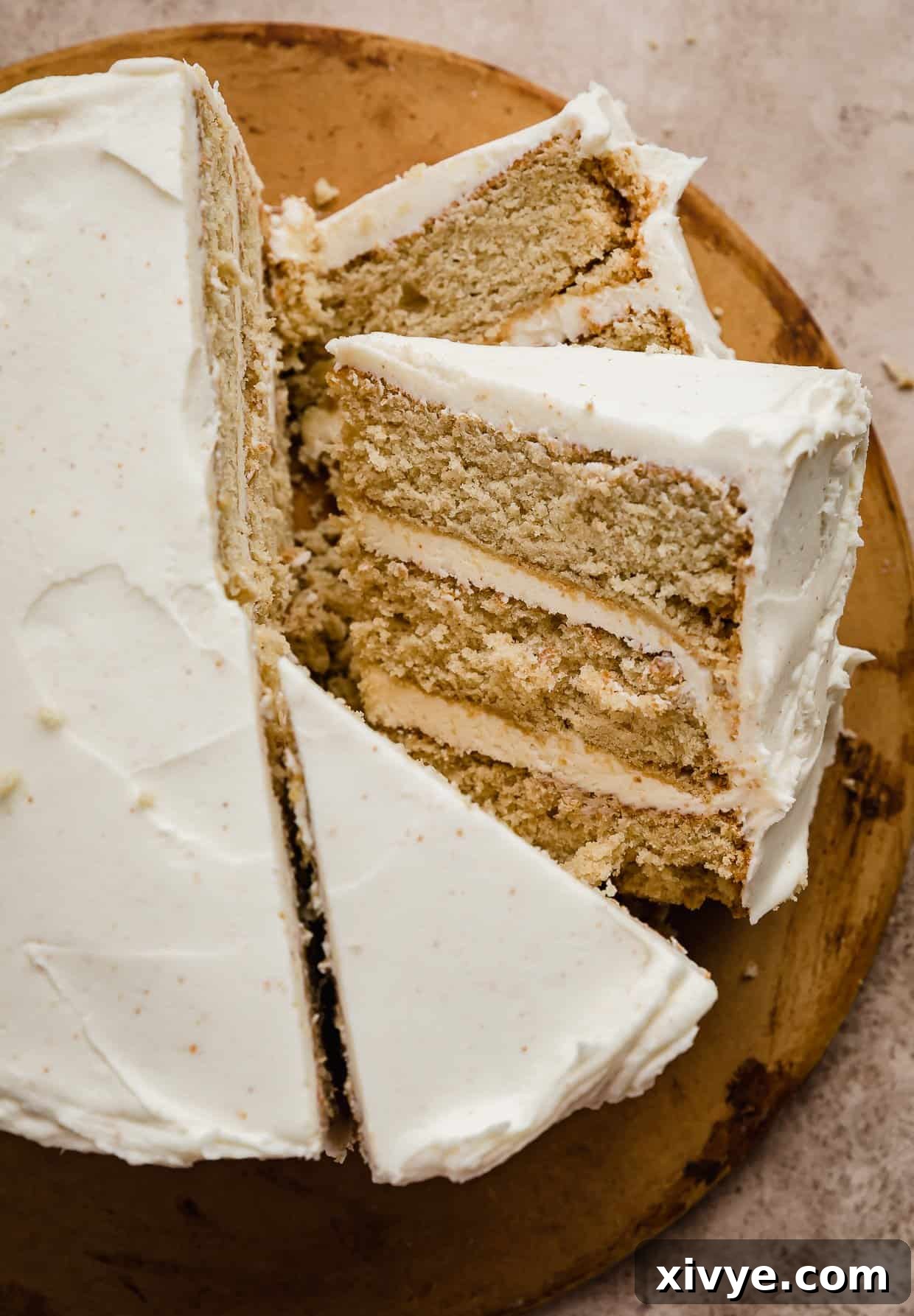 Toasted Butter Dream Cake 8 Slices of Brown Butter Cake topped with brown butter frosting on a brown background.