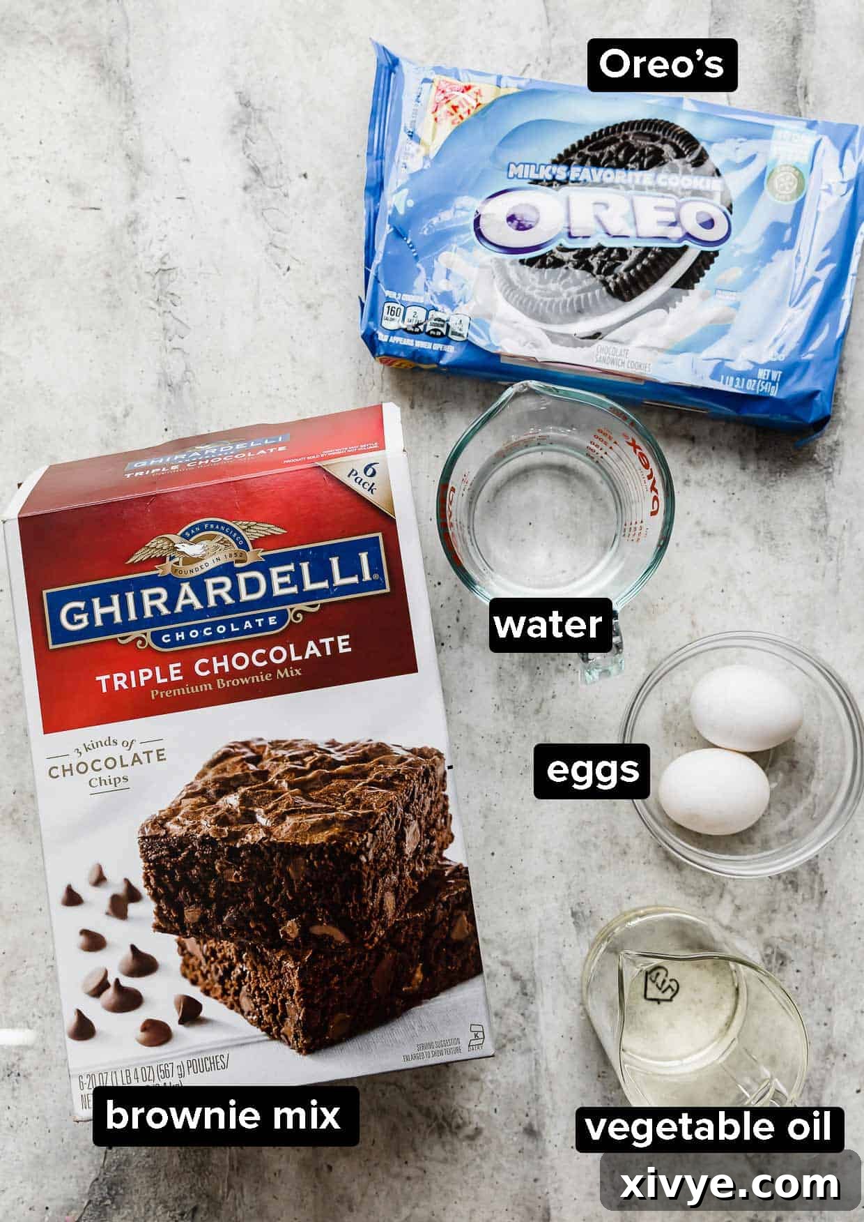 Cookies and Cream Fudge Brownies 3 Ingredients used to make Oreo brownies on a gray background: boxed brownie mix, Oreos, water, eggs, vegetable oil.