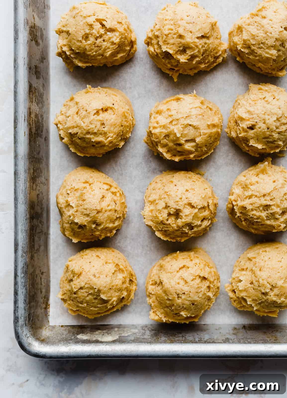 pumpkin dough balls on a baking sheet.