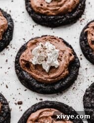 Crumbl copycat French silk pie cookies recipe on a white background with chocolate shavings around the cookies.