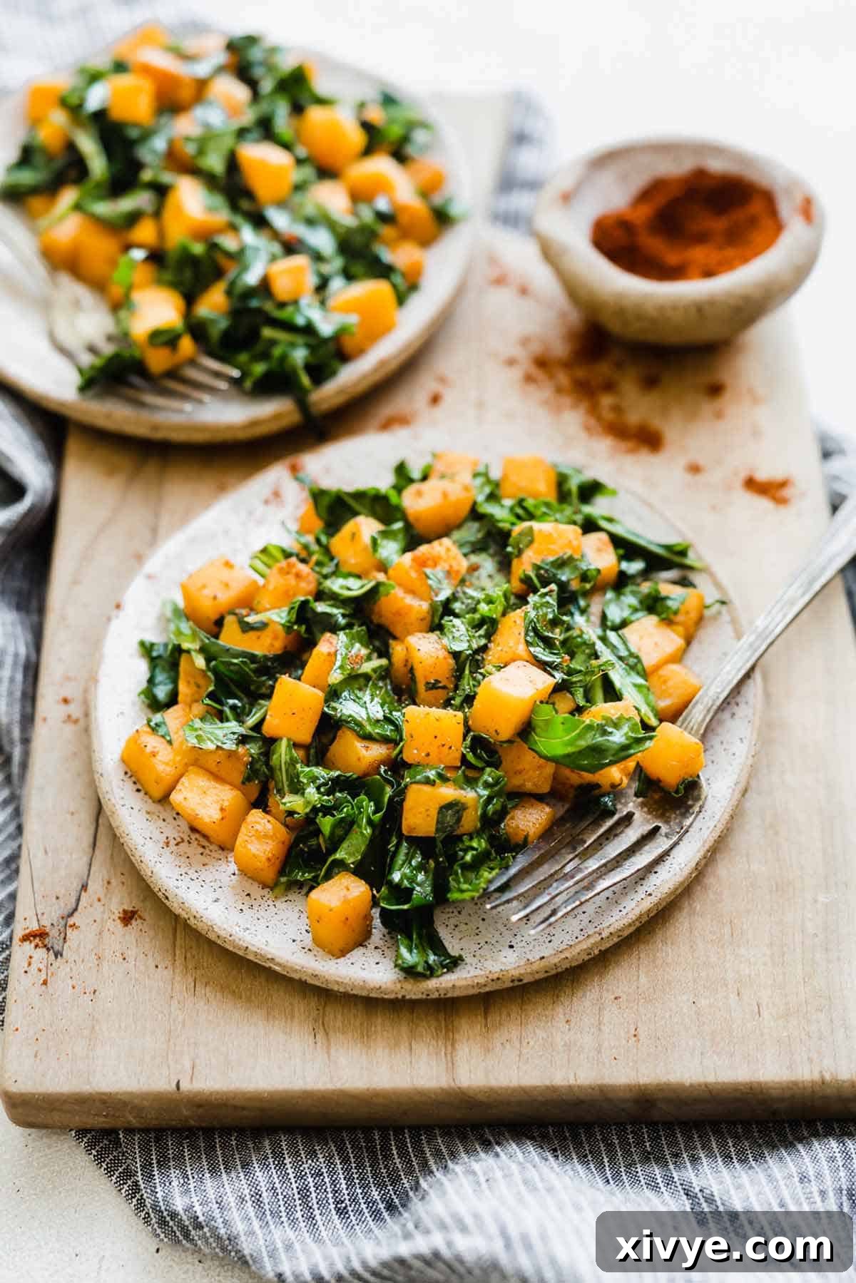 Butternut Squash and Kale Delight 2 Butternut Squash and Kale on a white plate, showcasing the vibrant colors and tender textures of the perfectly cooked vegetables.