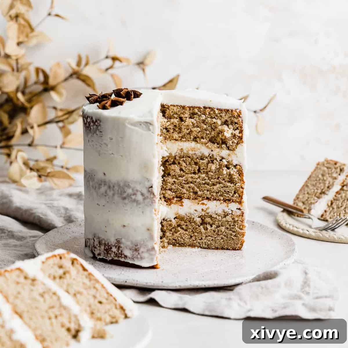 A close-up shot of a wonderfully moist Spice Cake, richly frosted with smooth cream cheese frosting, ready to be enjoyed.