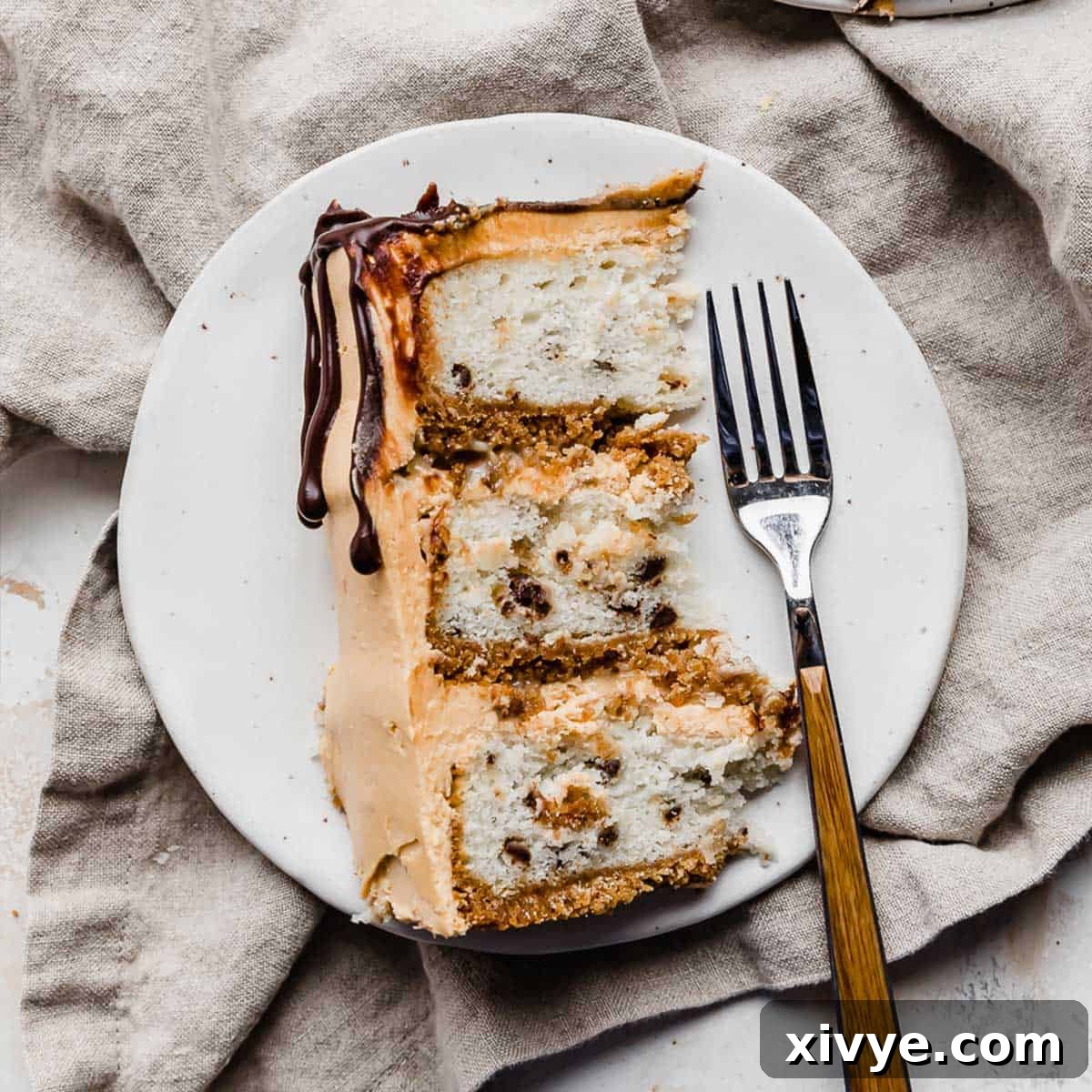 A perfectly portioned slice of 7 Layer Bar Cake resting on a white plate, revealing its delicious layers and textures.