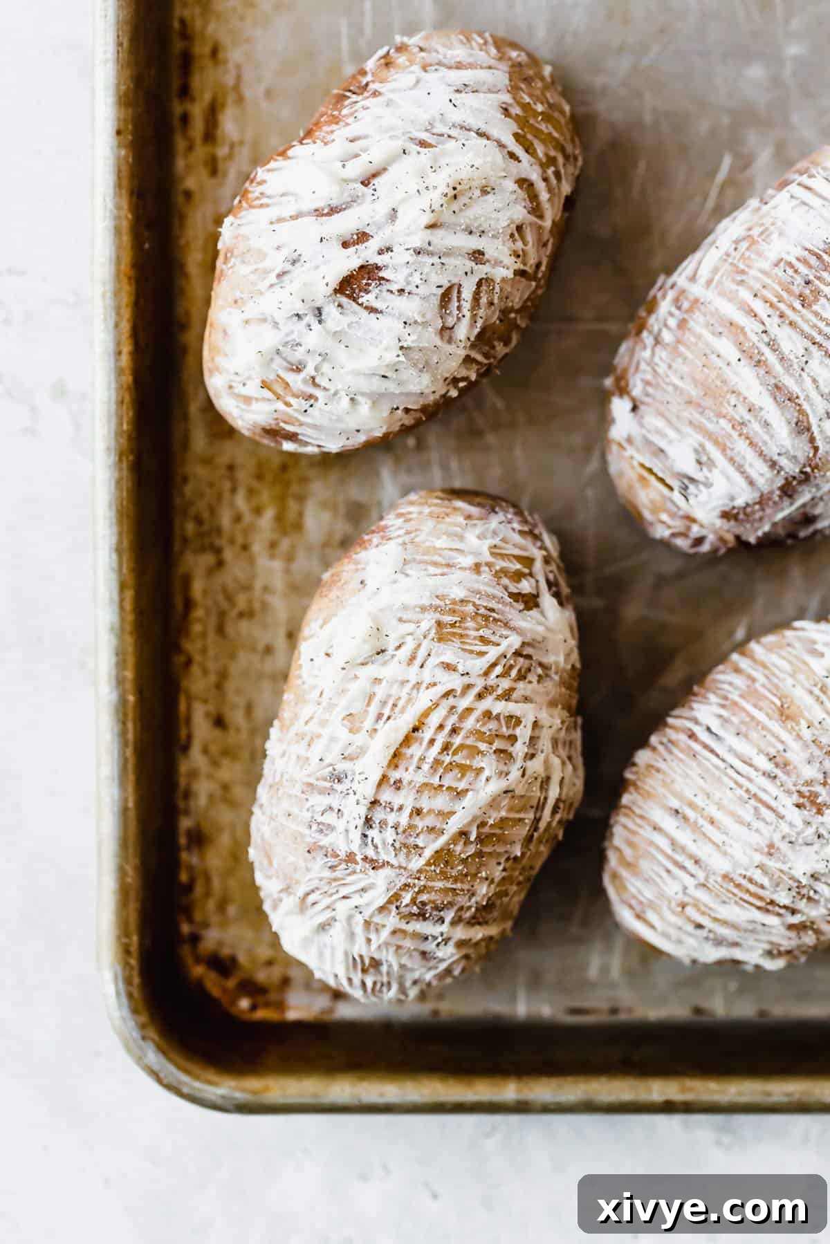 Crispy Air-Fried Hasselback Potatoes 3 Softened butter spread over russet potatoes topped with salt and pepper.