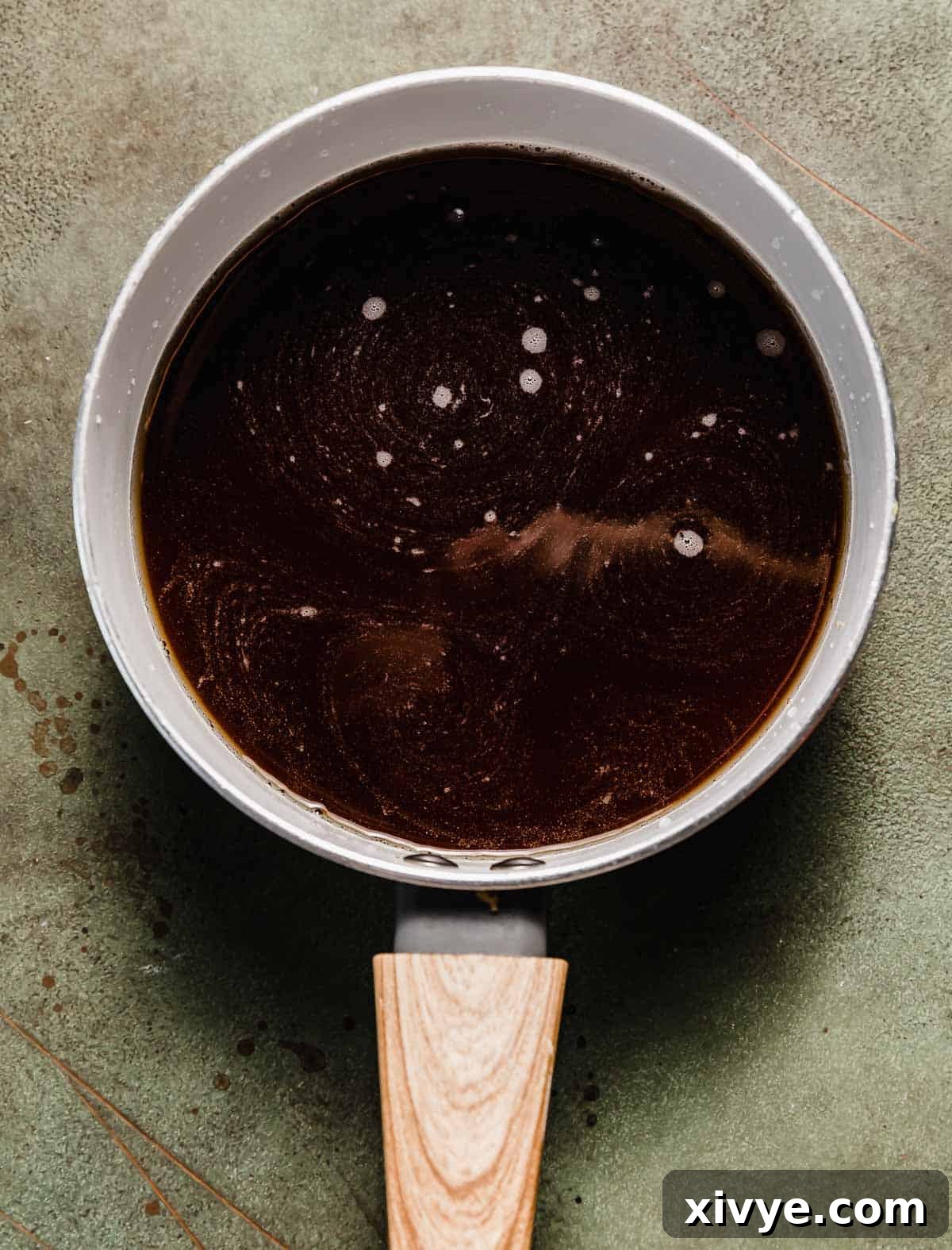 A white saucepan with a Gingerbread Syrup mixture in the pan.
