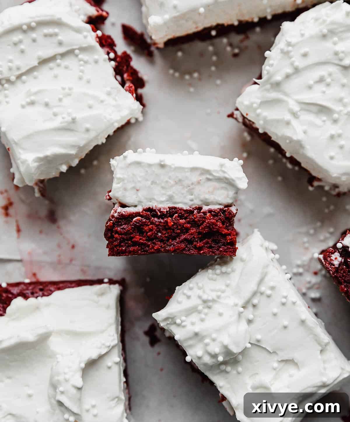 Red Velvet Brownies with cream cheese frosting on a white background.