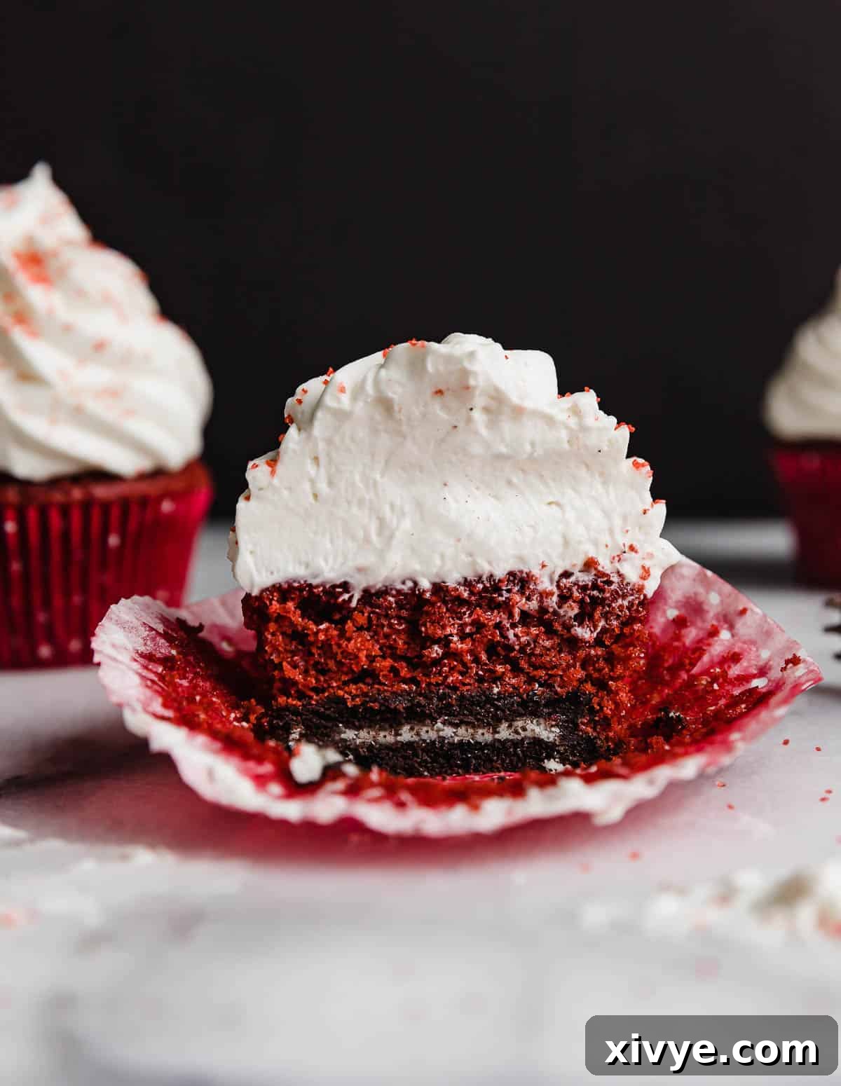 A red velvet cupcake baked on top of an Oreo.