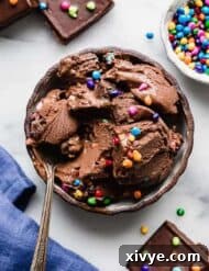 Stardust Brownie Galaxy 9 Cosmic Brownie Ice Cream in a small black bowl on white marble background.