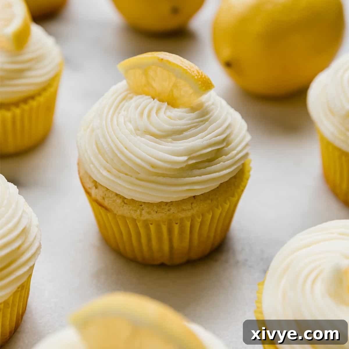 A lemon cupcake topped with a swirl of Lemon Buttercream.