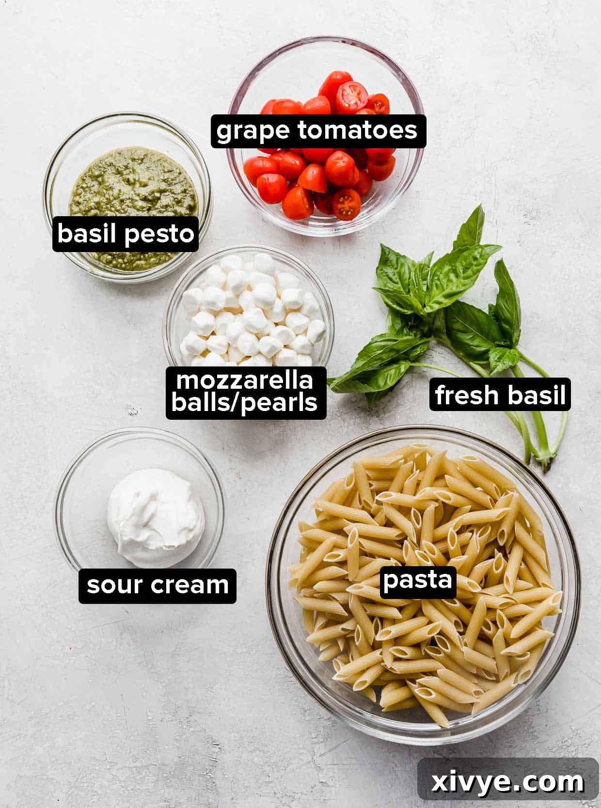 Ingredients used to make pesto pasta with tomatoes. 