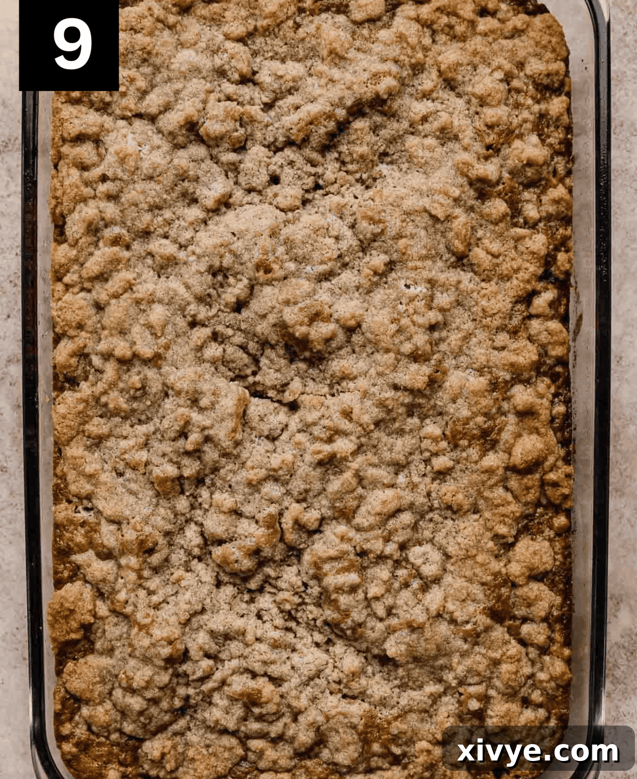 Banana Coffee Cake topped with a sugar, flour, melted butter topping in a rectangle baking pan.