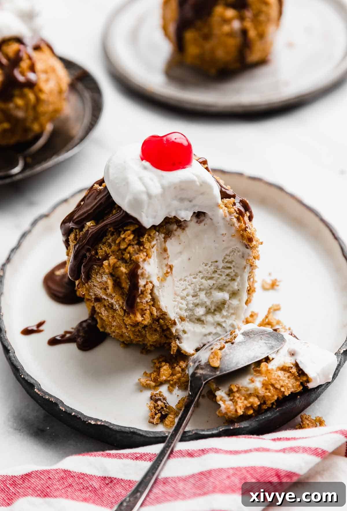 Golden Frost 2 No Fry Fried Ice Cream topped with hot fudge, whipped cream and maraschino cherry.