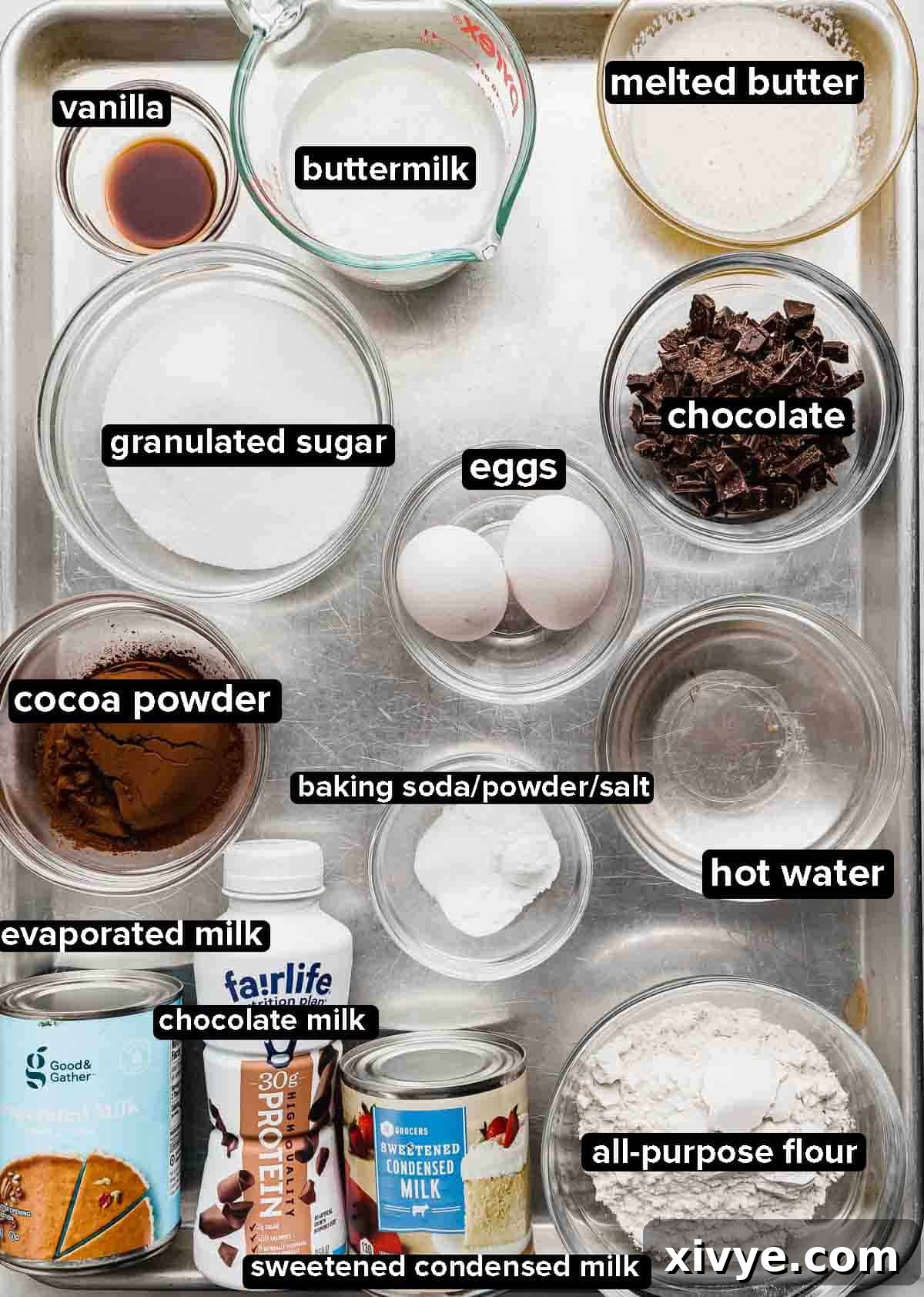 Heavenly Chocolate Tres Leches Cake 3 Chocolate Tres Leches Cake ingredients portioned into glass bowls on a silver baking tray.