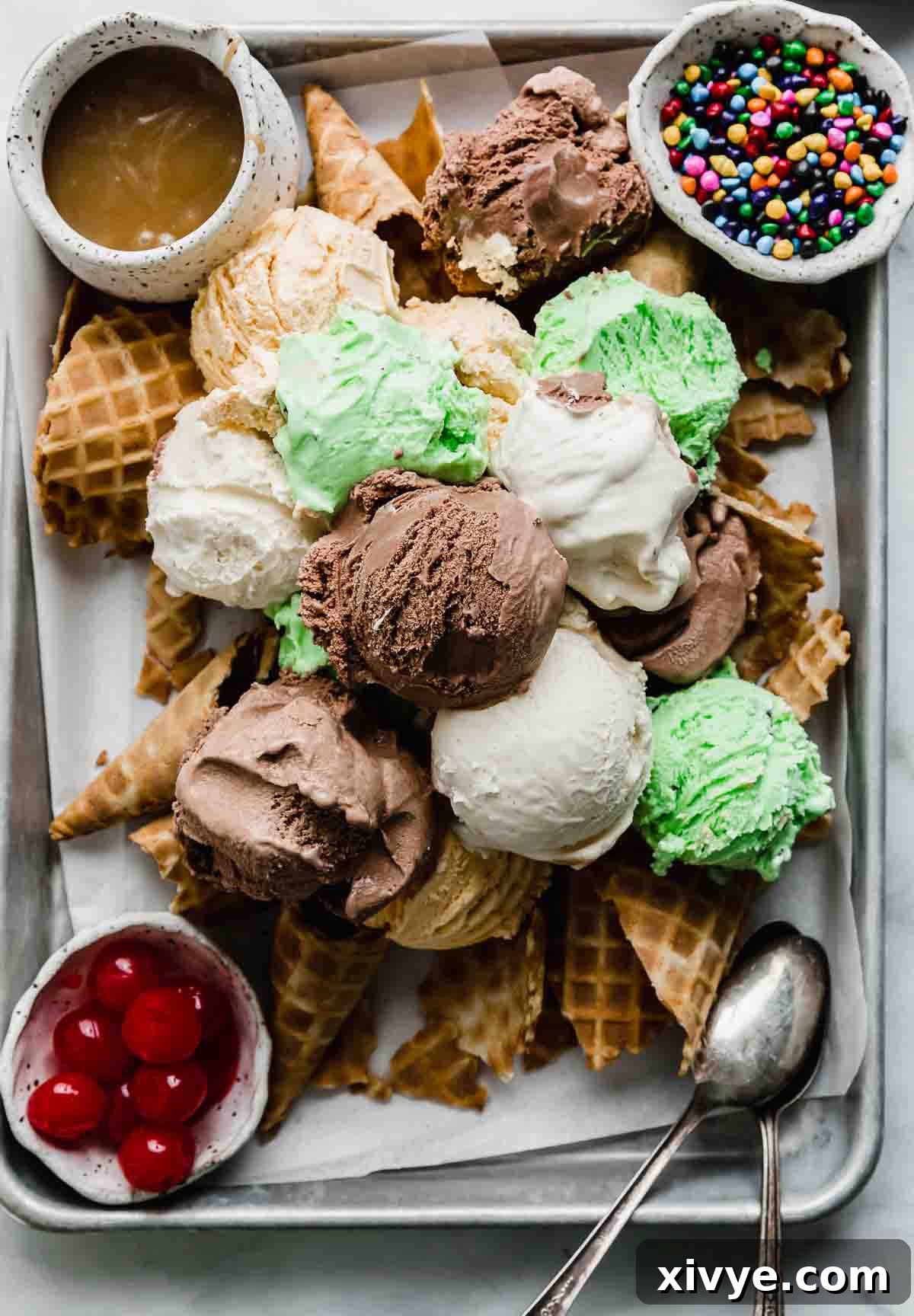 Chocolate, vanilla, and mint chip scoops of ice cream on top of crunched up waffles cones (Ice Cream Nachos).