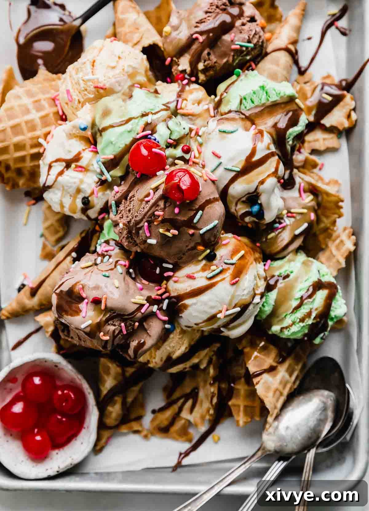 Close up of Ice Cream Nachos topped with hot fudge, butterscotch sauce, sprinkles, and maraschino cherries.