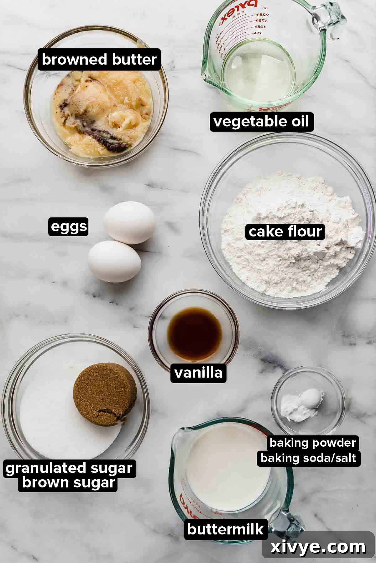 Golden Butterscotch Delights 3 Butterscotch Cupcake ingredients portioned into glass bowls on a white and gray marble background.