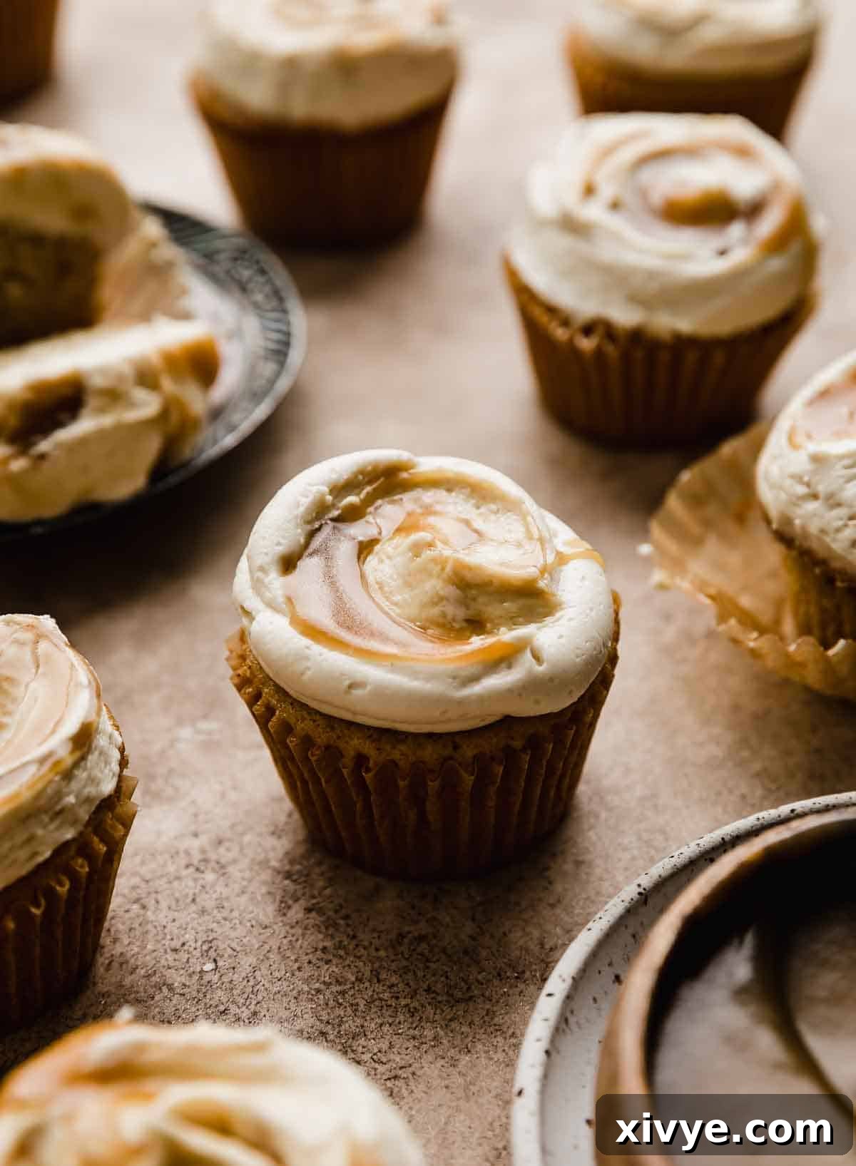 Golden Butterscotch Delights 8 Homemade butterscotch frosting topped frosting on a Butterscotch Cupcake on a brown background.