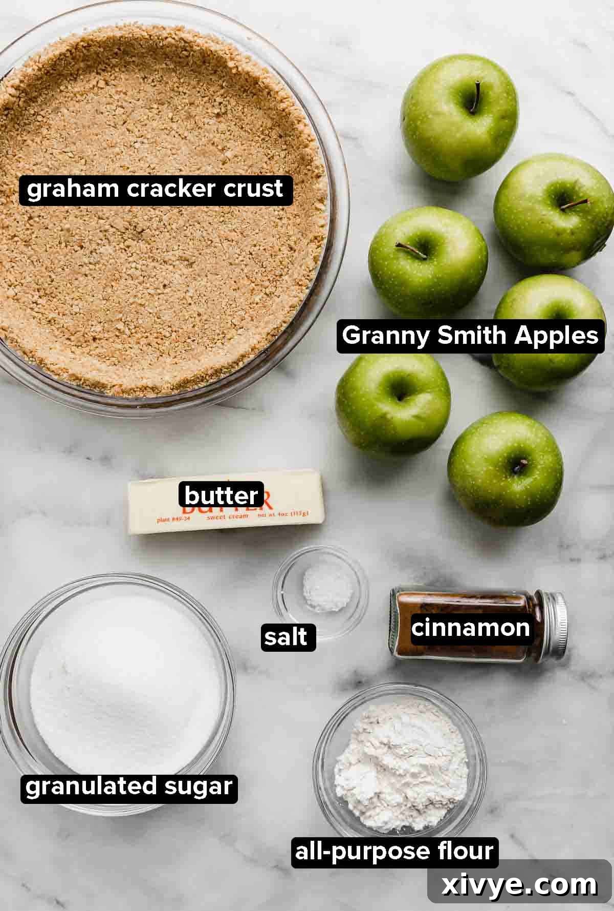Autumn Apple Pie Graham Cracker Crunch 4 Key ingredients for Apple Pie with Graham Cracker Crust, including a prepared graham cracker crust, crisp Granny Smith apples, butter, sugar, flour, cinnamon, and salt.